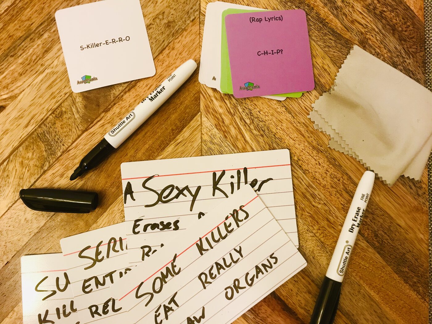 AcroMania dry-erase answer cards filled in mid-game with funny answers